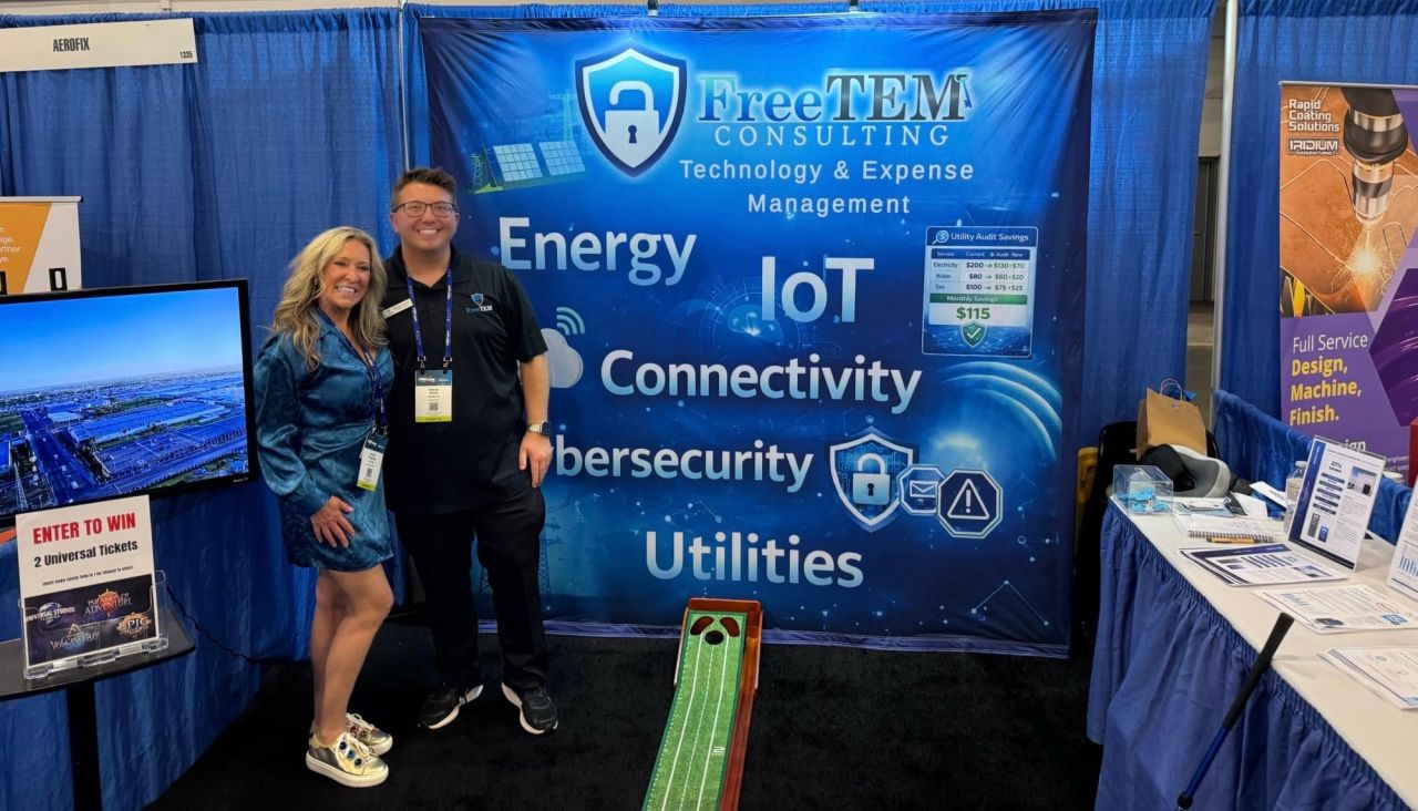FreeTEM team at its PBExpo booth with a technology and expense management display