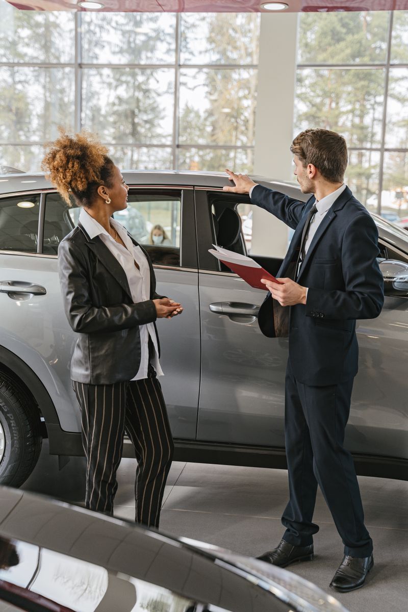 Service advisor greeting a customer at a car dealership