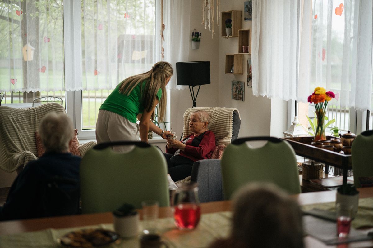 Caregiver supporting a senior resident