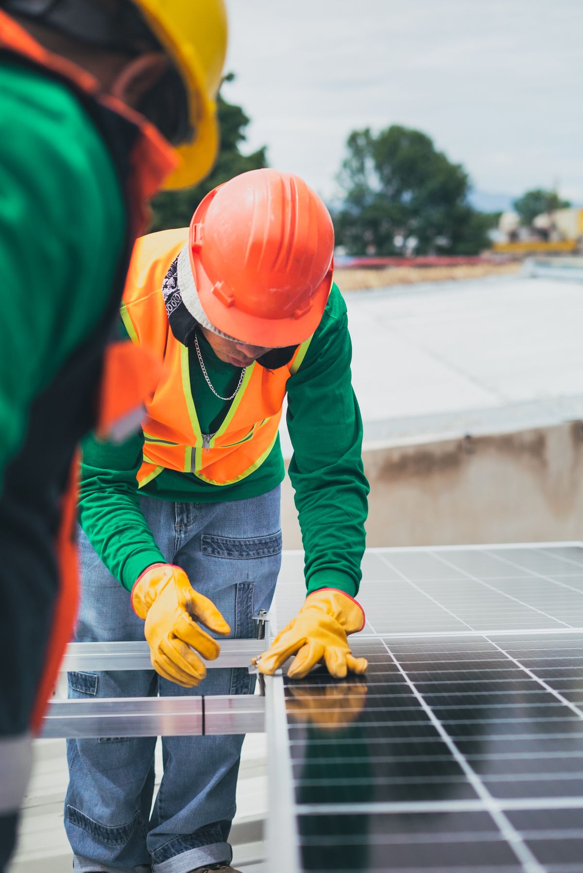 Technicians installing rooftop solar panels