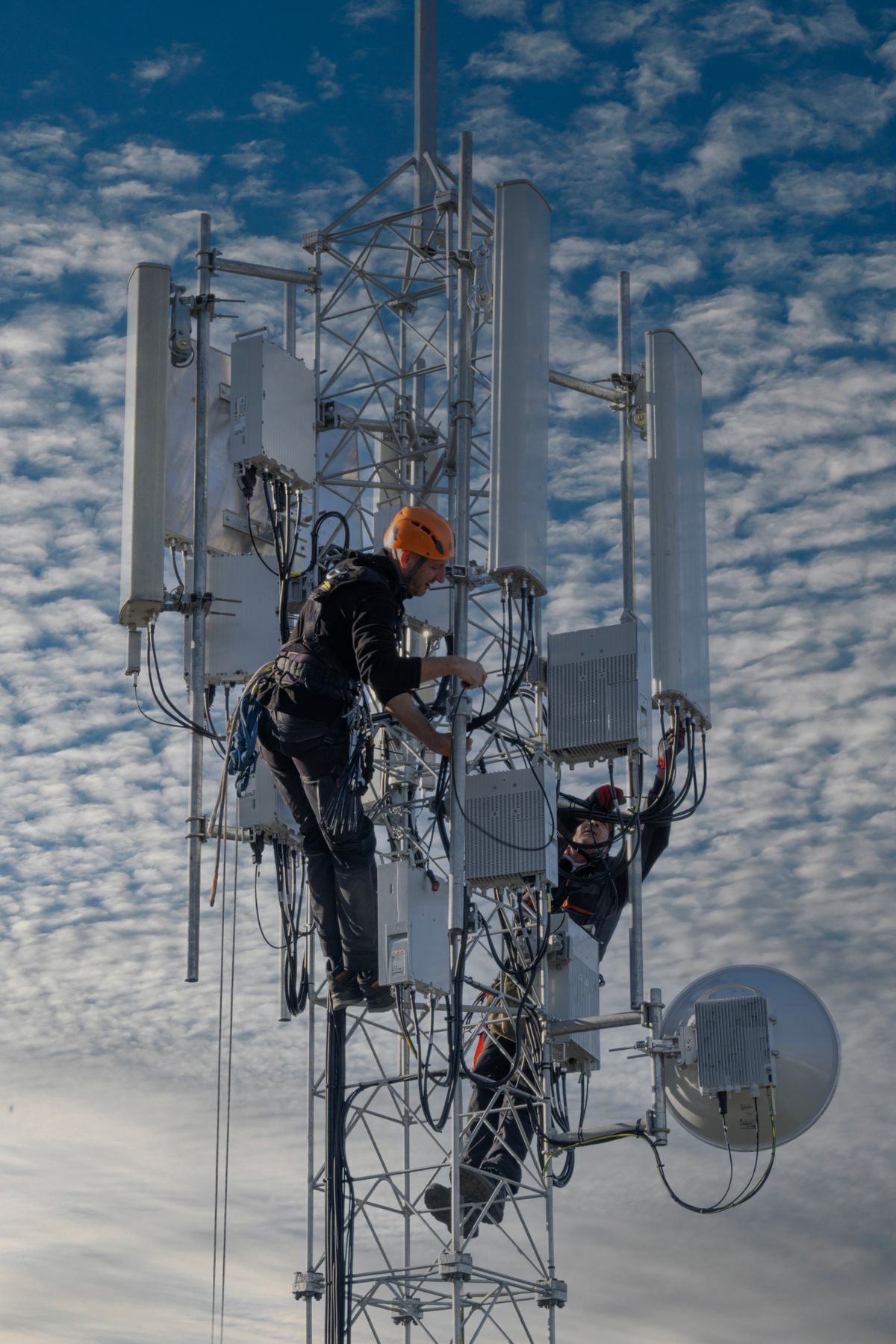 Telecom technicians working on a communications tower
