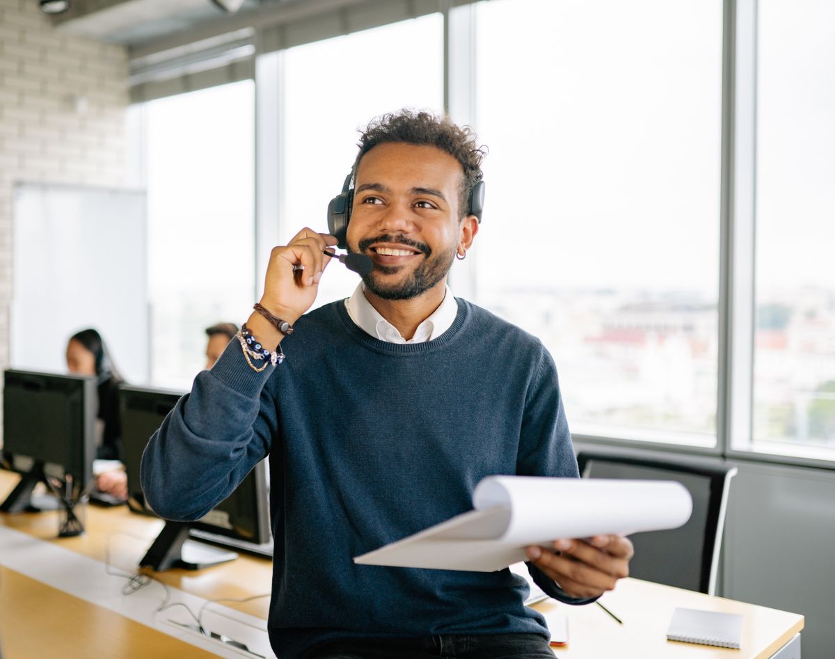 Customer-experience agent wearing a headset at a desk